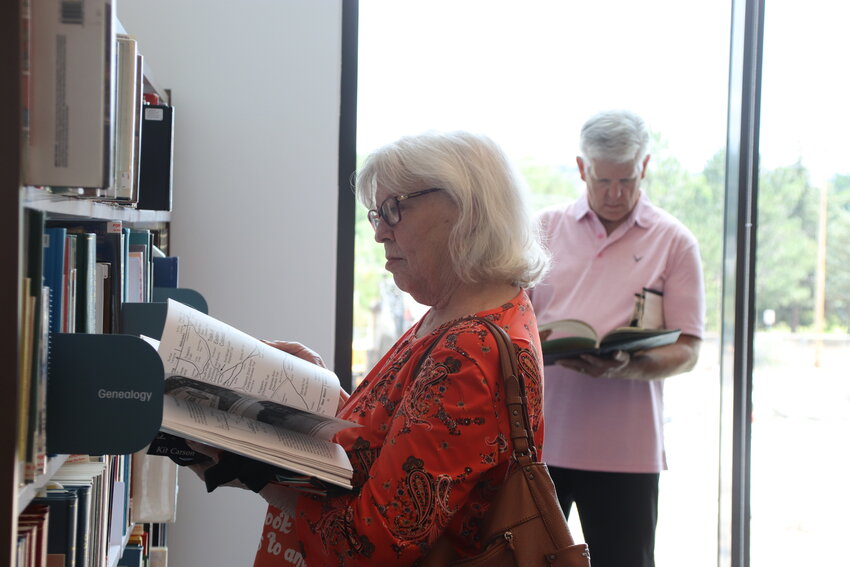 Littleton resident Diane Pierce looks at a book about the Cherokee Trail in the Sjostrom History Lounge. Pierce said she used to live in Castle Rock and had to come to celebrate the library’s opening.